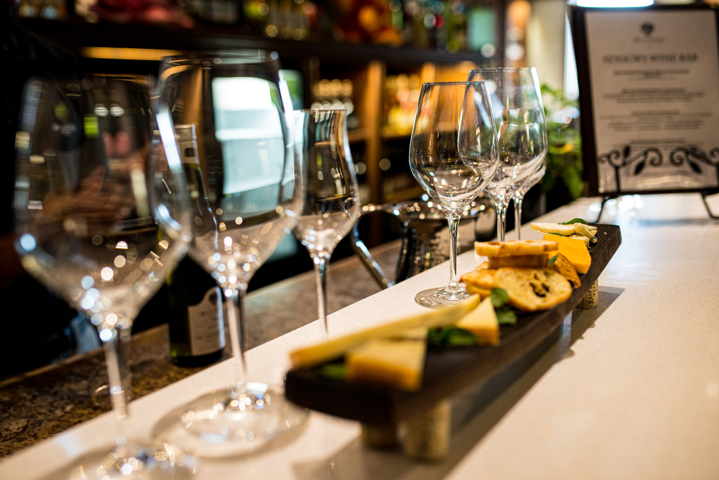 Wine tasting event displaying wine glasses and cheese & crackers.